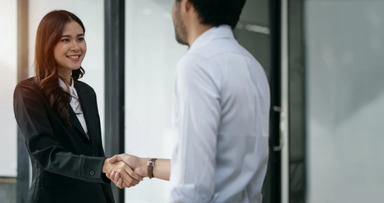 happy-young-businesswoman-shaking-hands-with-job-candidate-office_converted
